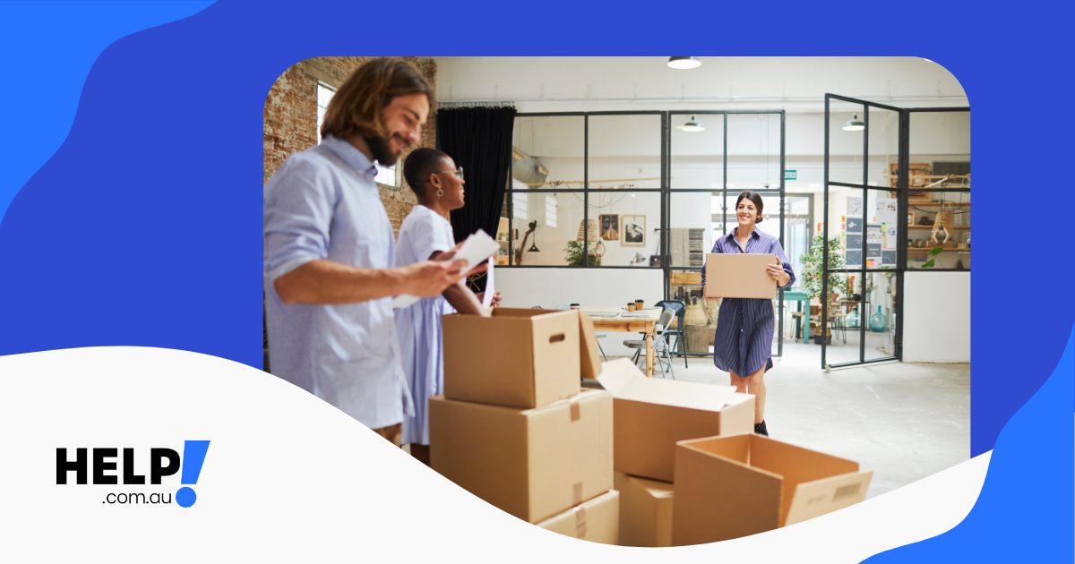 A group of employees unpacking boxes within their new office space.